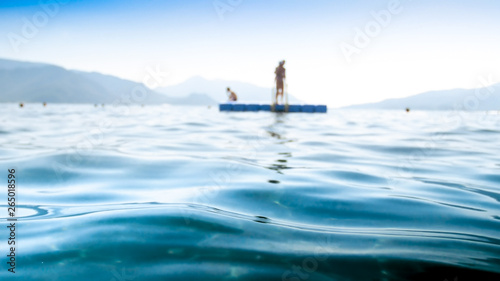 Out of focus image of calm sea waves against floating pier © Кирилл Рыжов