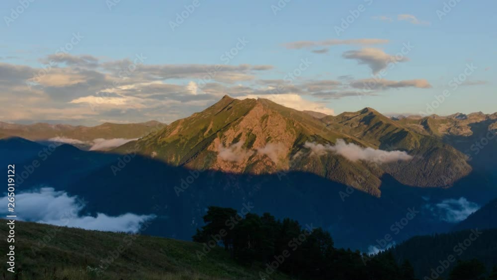 Sunset in the mountains. The shadow moves along the slope of the mountain. Clouds swirl in the mountain gorge. Time lapse 4K. Arkhyz, Caucasus, Russia Sunset in the mountains. The shadow moves along the slope of the mountain. Clouds swirl in the mountain gorge. Time lapse 4K. Arkhyz, Caucasus, Russia