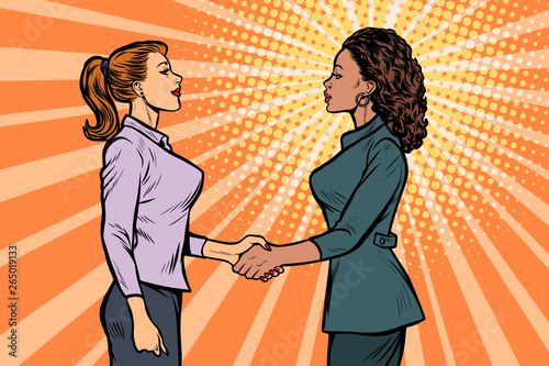 African and Caucasian businesswomen shaking hands