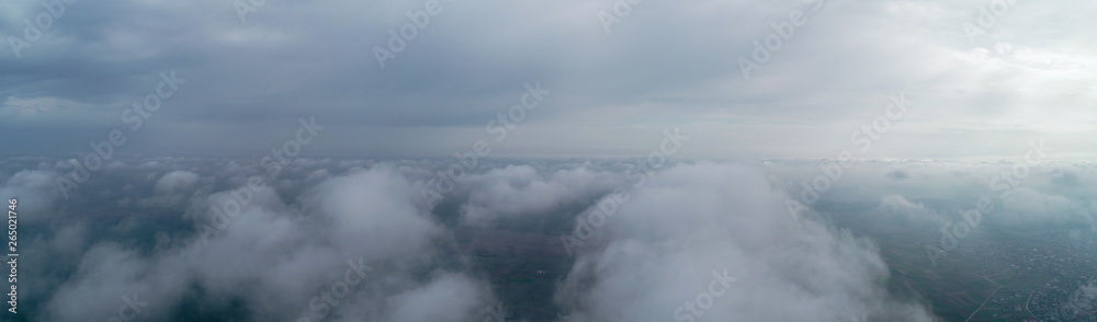 Flight over the clouds, panorama. Weather 