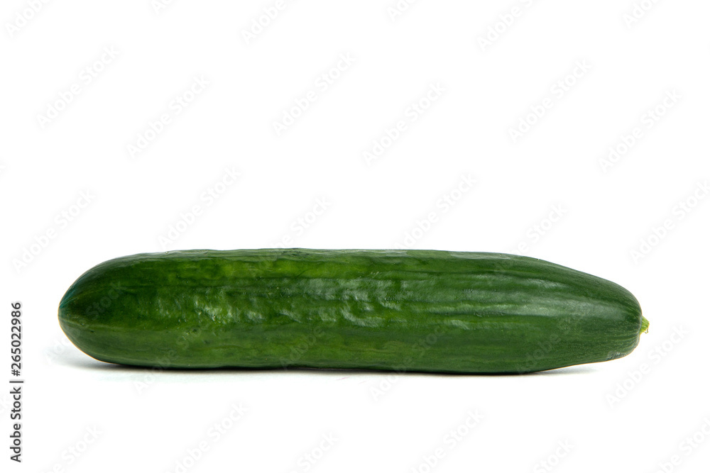 Green cucumber Isolated on white. Ground cucumber ready to be cooked. The cucumber lies on the counter, the concept of cooking and preparing a meal. Dishes for vegetarians. Green cucumber Isolated on white. Ground cucumber ready to be cooked. The cucumber lies on the counter, the concept of cooking and preparing a meal. Dishes for vegetarians.