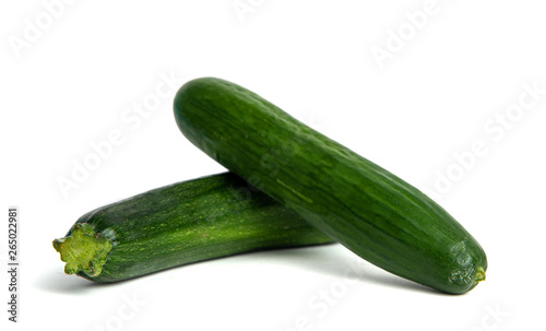 Green cucumber and zucchini isolated on a white background. The concept of eating vegetables, providing vitamins and healthy eating. Comparison of courgettes and cucumbers.