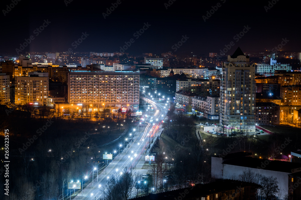 Night road with houses. Street with LED lights. Illumination of the avenue with white light.