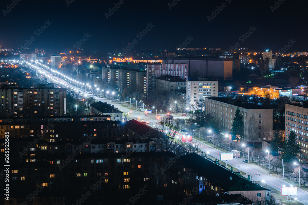 Fototapeta premium Night road with houses. Street with LED lights. Illumination of the avenue with white light.