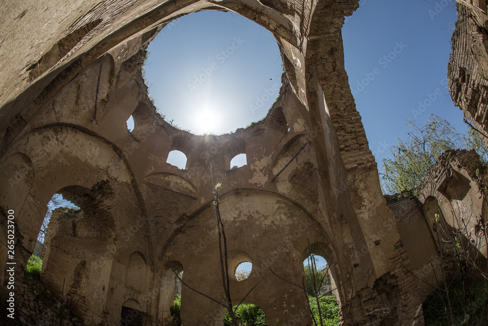 Photo of abandoned church in Devichi, Azerbaijan. Red brick orthodox old church ruins against a landscape. Abandoned places