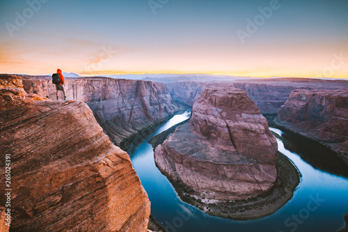Obraz na płótnie Hiker overlooking Horseshoe Bend at sunset, Arizona, USA w salonie