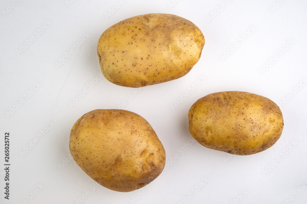 vegan diet: fresh raw organic potatoes, on white, short focus vegan diet: fresh raw organic potatoes, on white, short focus