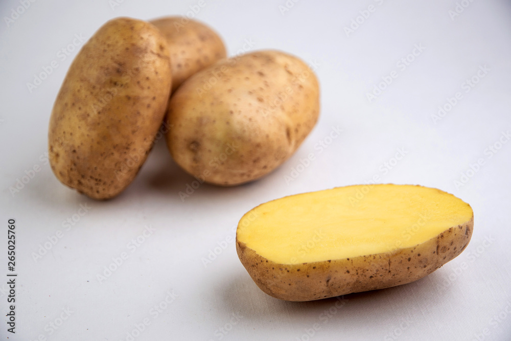 vegan diet: fresh raw organic potatoes, on white, short focus vegan diet: fresh raw organic potatoes, on white, short focus