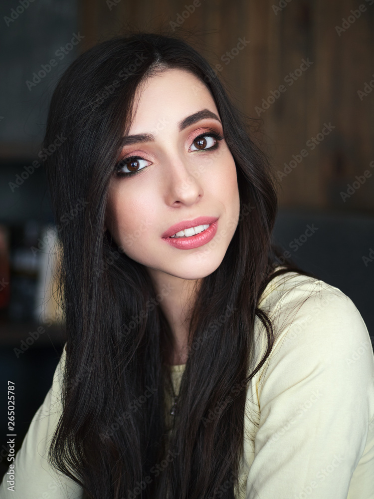 Portrait of young beautiful smiling woman enjoying weekend free time in cozy coffee shop cafe vintage film color tone. City lifestyle concept.