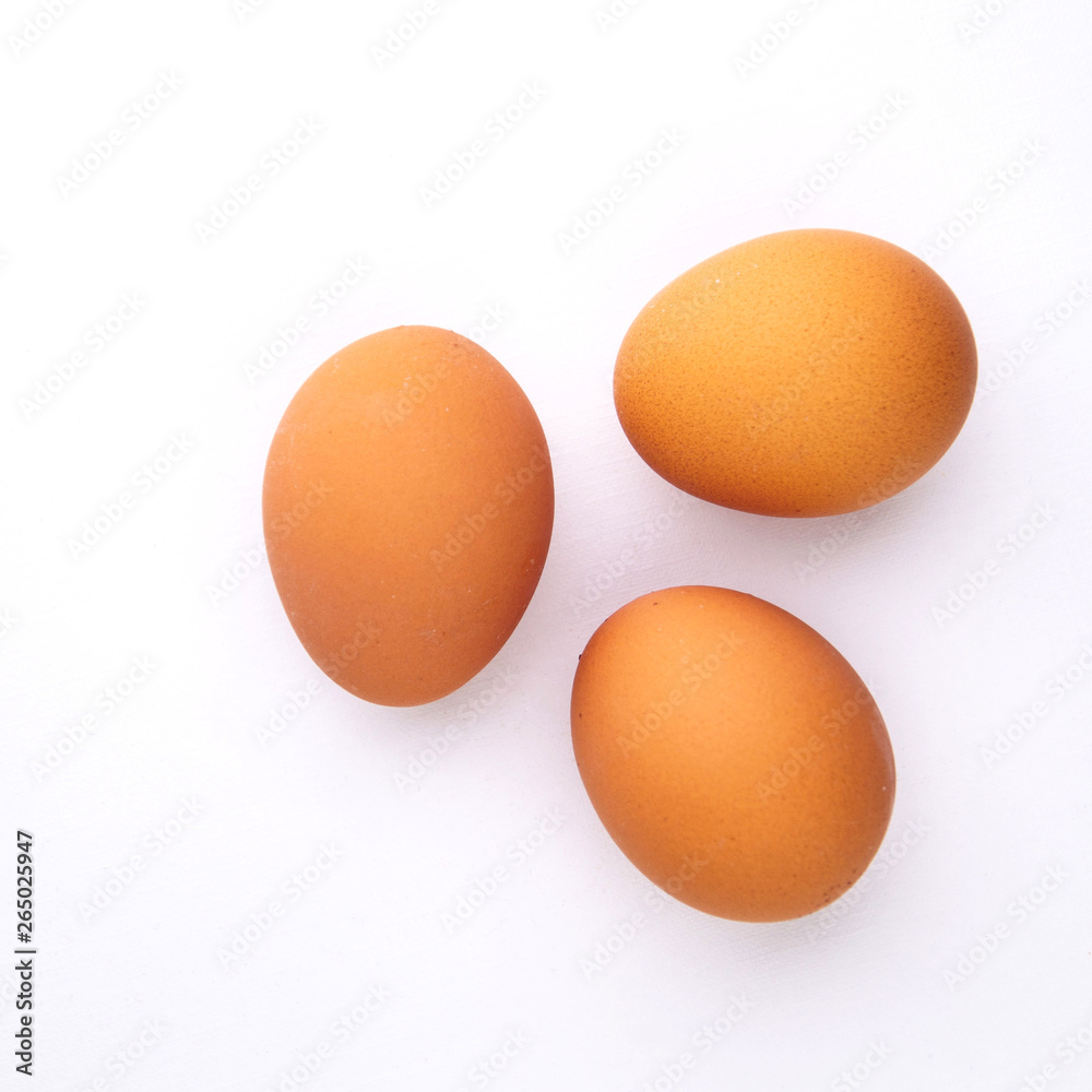 3 chicken eggs on a white background with shadows 3 chicken eggs on a white background with shadows