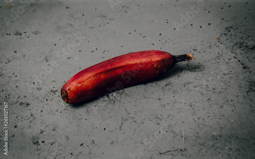 Red banana on a dark background. Exotic fruits ready to eat.