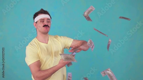 funny man with a mustache throws money and looks at the camera