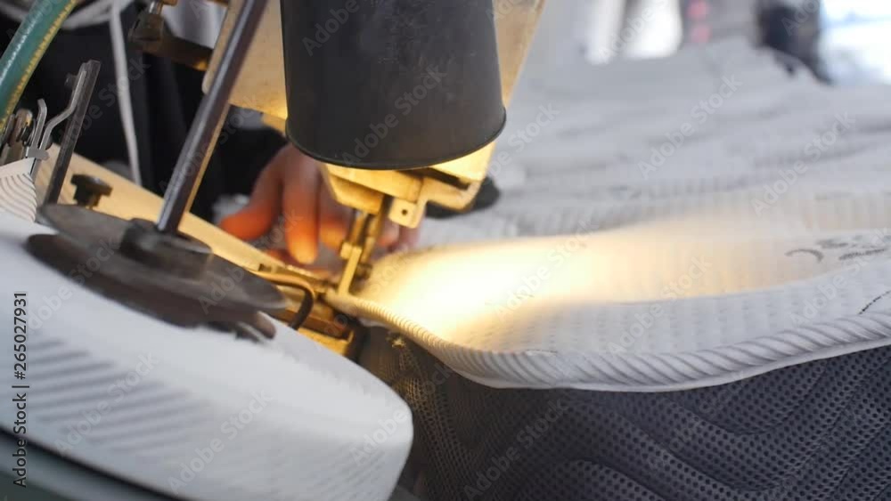 Worker sewing mattress. Production process in manufacture