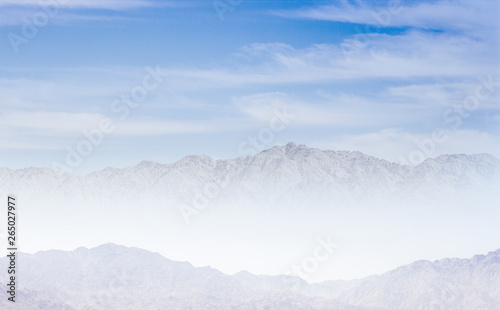 mystic dramatic mountain in morning fog picturesque scenery landscape in white and blue colors 