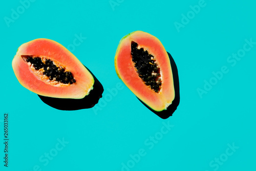 Fresh cut papaya with ceeds on blue background. photo