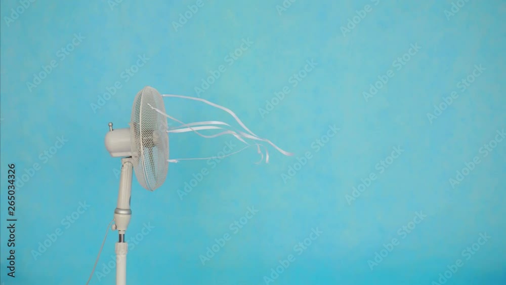 Electric fan on blue background