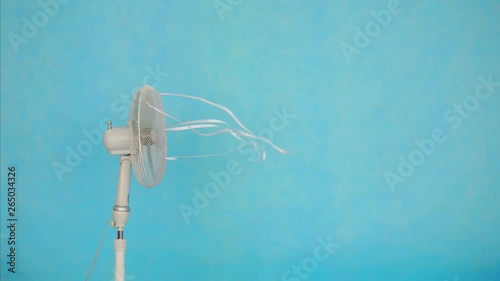 Electric fan on blue background