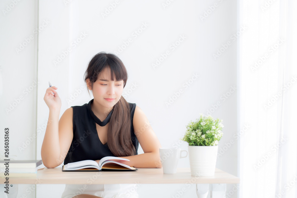 Beautiful asian woman writer thinking idea and writing on notebook or diary with happy on desk office, lifestyle of asia girl is success, female planning working, education and business concept.