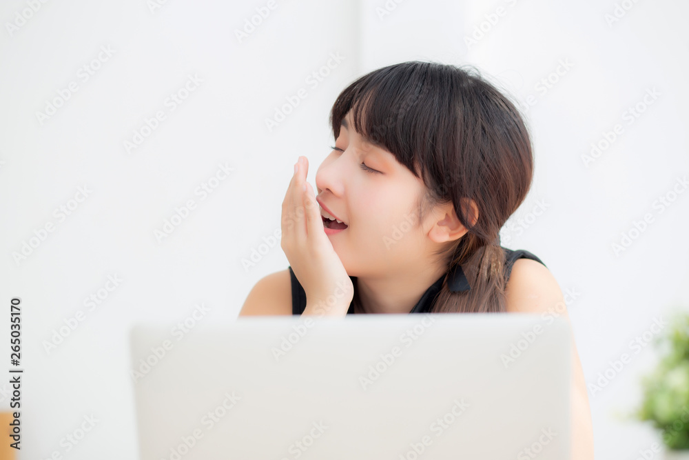 beautiful young freelance asian woman working bored and tired on laptop computer at the office, girl lazy sleepy and yawning on notebook, female secretary with exhausted, business concept. beautiful young freelance asian woman working bored and tired on laptop computer at the office, girl lazy sleepy and yawning on notebook, female secretary with exhausted, business concept.