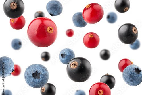 Falling berries, cranberry, blueberry, black currant, isolated on white background