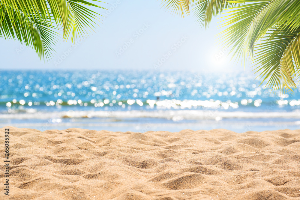 Fototapeta Abstract seascape with palm tree, tropical beach background. blur bokeh light of calm sea and sky. summer vacation background concept.