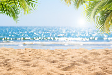 Abstract seascape with palm tree, tropical beach background. blur bokeh light of calm sea and sky. summer vacation background concept.
