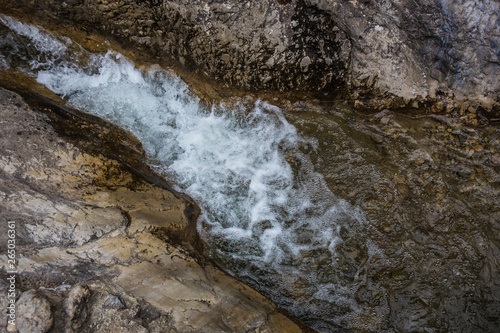 flow of water between the rocks of a mountain stream © Yuri Bizgaimer