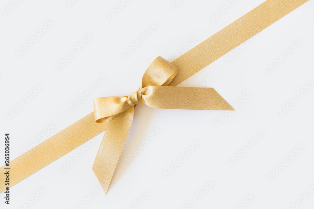 Fototapeta premium Gold ribbon with a bow as a gift on a white background