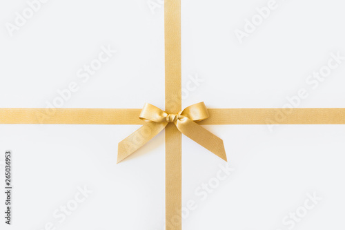 Gold ribbon with a bow as a gift on a white background