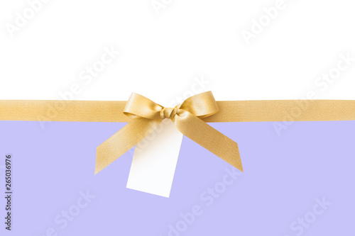Gold ribbon with a bow as a gift on a white and violet background
