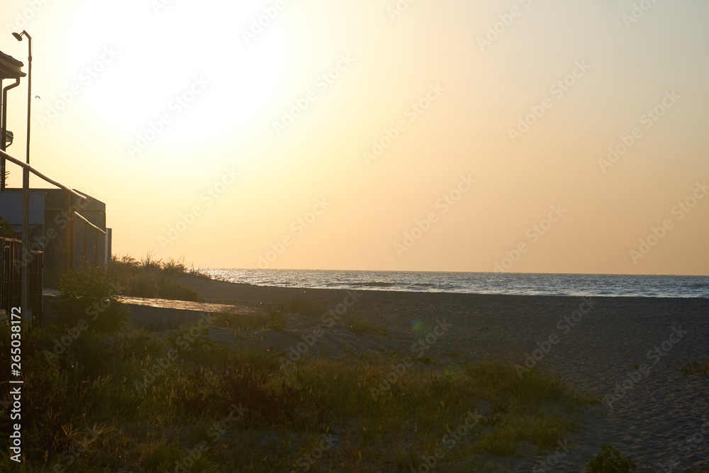 beautiful sandy beach, sunset and sea wave