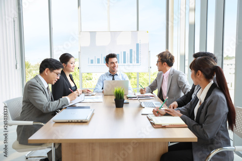 caucasian businessman showing success business profit graph from white board in meeting with smile and happy face