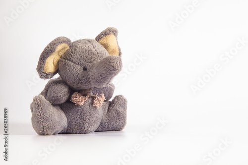 Funny cute grey gray plush elephant toy isolated on color background. Isolated, blue, red, white. Copy space for text.