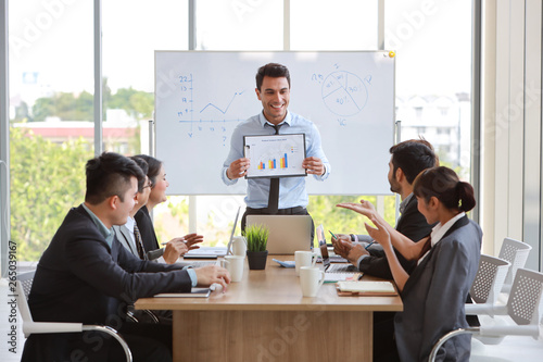 businessman showing success business profit graph in meeting with smile and happy face