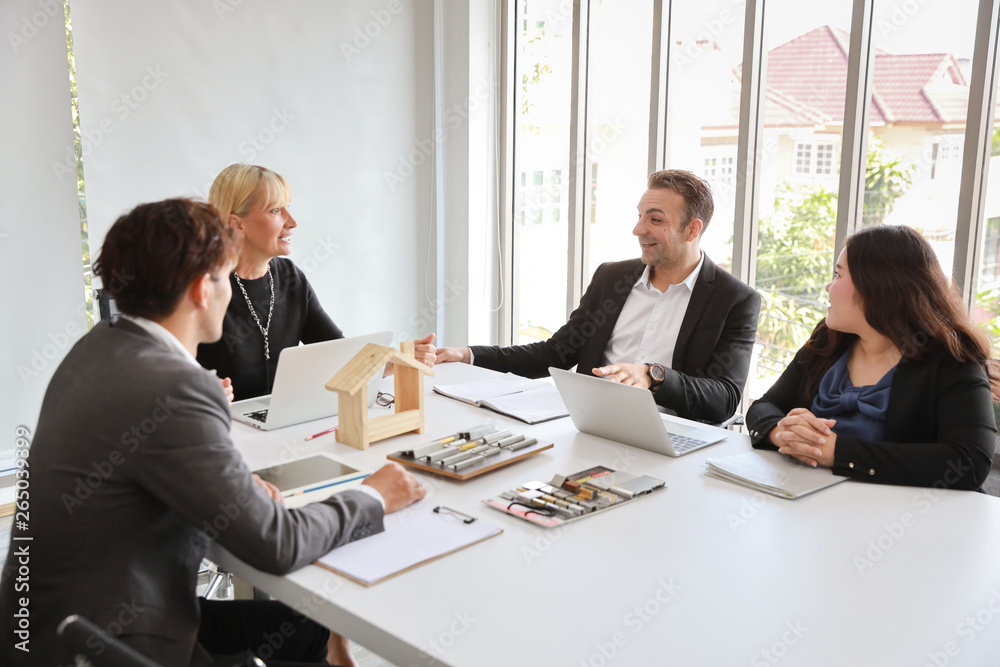 Multiethnic business people discussing company about new house project in meeting room with smiling and happy faces Multiethnic business people discussing company about new house project in meeting room with smiling and happy faces
