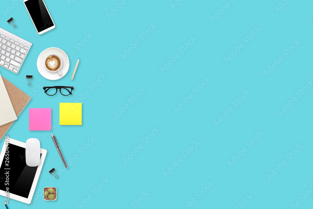 digital marketing work desk with laptop computer, office supplies, coffee cup and cell phone on green pastel background