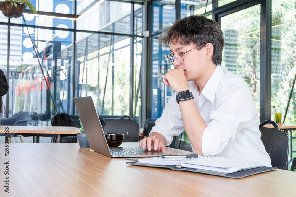 young businessman working with mobile laptop and documents in office, business concept young businessman working with mobile laptop and documents in office, business concept