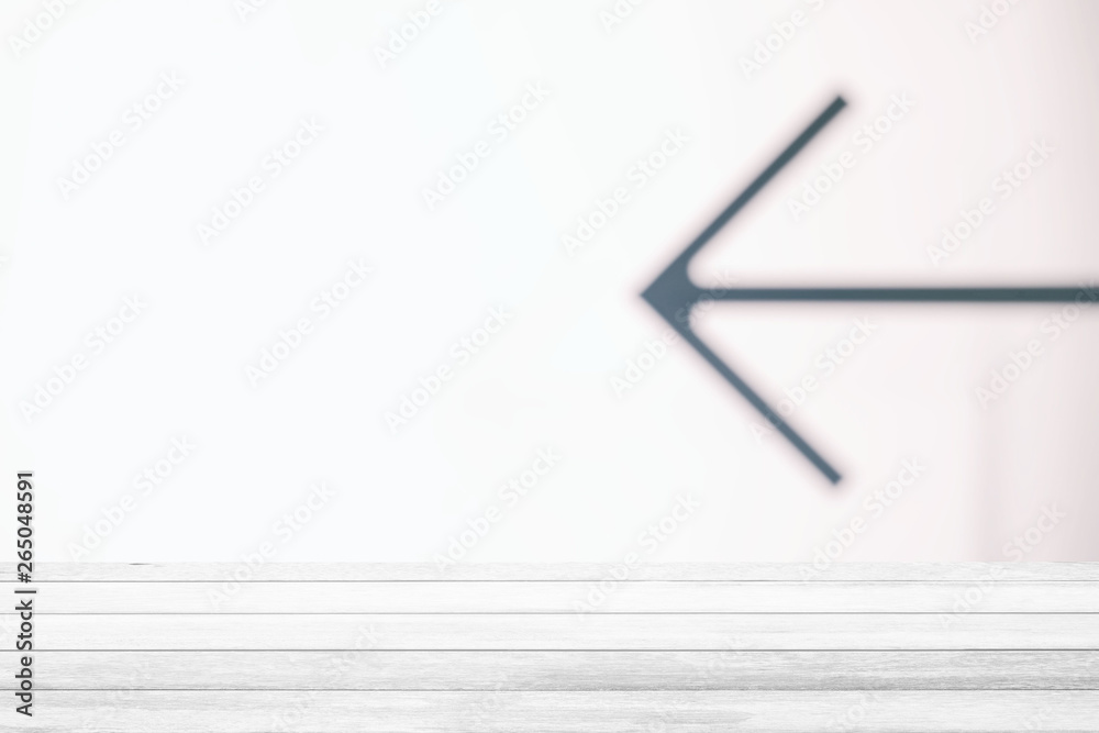 White Wood Table with Blurred Arrow Sign Background, Suitable for Product Display. White Wood Table with Blurred Arrow Sign Background, Suitable for Product Display.