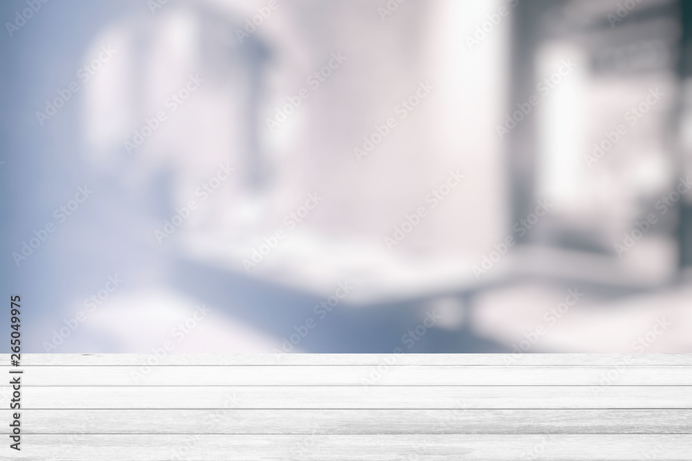 White Wood Table with White Bokeh of Interior Restaurant Room Background, Suitable for Product Display. White Wood Table with White Bokeh of Interior Restaurant Room Background, Suitable for Product Display.