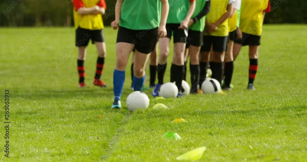 4K Young female soccer team practice dribbling & ball skills in training session. Slow motion. 4K Young female soccer team practice dribbling & ball skills in training session. Slow motion.