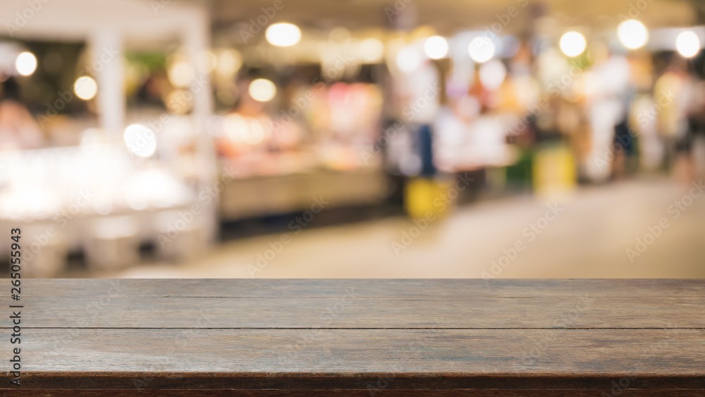 Empty wood table top on abstract blurred restaurant and street food lights background - can be used for display or montage your products Empty wood table top on abstract blurred restaurant and street food lights background - can be used for display or montage your products