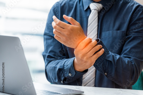 Closeup business man holding wrist pain. Health concept, Office syndrome. 