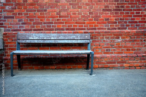 Old Wooden Bench with Brick Wall Background.