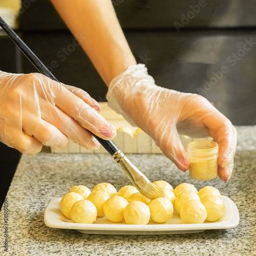 The process of making handmade candies. Chocolatier Brings Candurin on White Chocolate Candy. Selective focus. photo