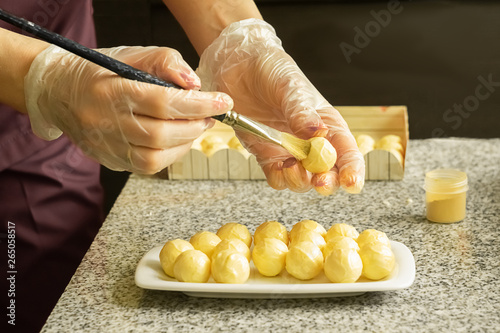 The process of making handmade candies. Chocolatier Brings Candurin on White Chocolate Candy. Selective focus. photo