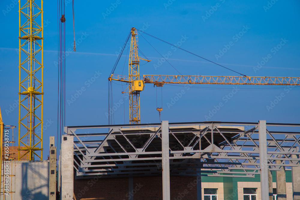 building crane and construction site over clear blue sky background