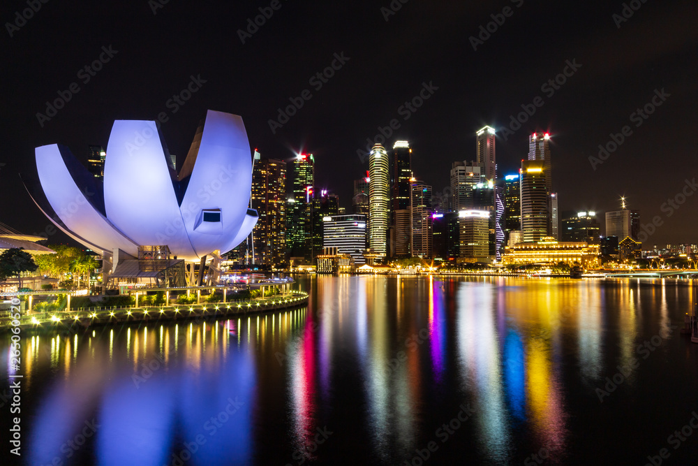 Fototapeta premium Singapore skyline cityscape with light around marina bay at night .