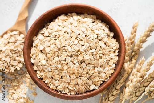 Oats, oat flakes or rolled oats in a bowl. Closeup view. Healthy clean eating food, healthy lifestyle concept