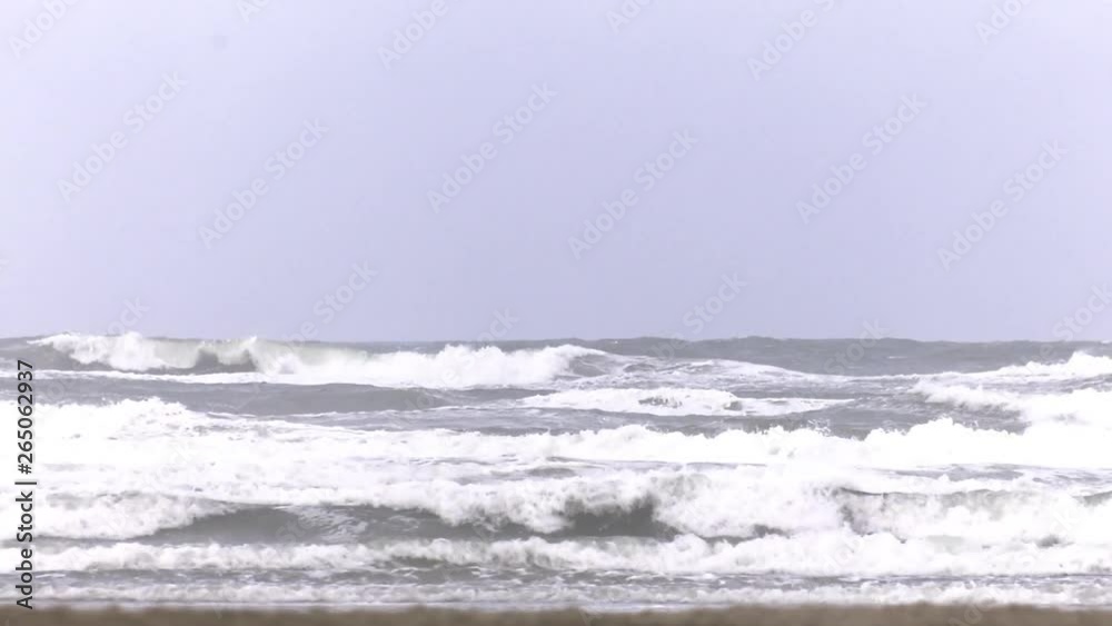 Serie of shots windy Winter holliday in the Netherlands on the Dutch Beach Island Terschelling. Waves on the beach shore Serie of shots windy Winter holliday in the Netherlands on the Dutch Beach Island Terschelling. Waves on the beach shore