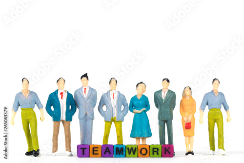 TEAMWORK text and Group of figure miniature businessman or small people investor and office worker secretary on white background for money and financial business teamwork concept.